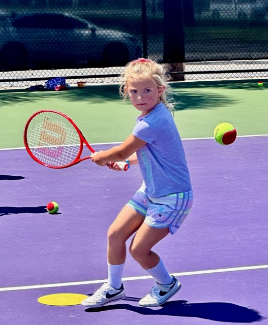 kid hitting red ball